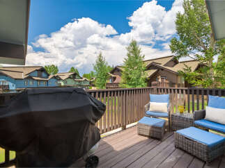 Enjoy outdoor living on this spacious deck, perfect for entertaining or relaxing.