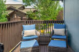 Enjoy your morning coffee or evening relaxation on this charming balcony, complete with comfortable seating and ottomans.