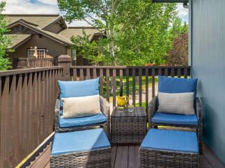 Enjoy your morning coffee or evening relaxation on this charming balcony, complete with comfortable seating and ottomans.