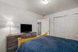 This cozy bedroom features a comfortable bed with a plush blue comforter, perfect for relaxing.