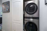 Discover the convenience of this modern stacked LG washer and dryer, perfect for maximizing space in your laundry area.