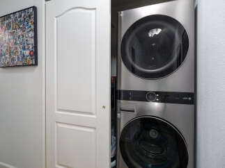 Discover the convenience of this modern stacked LG washer and dryer, perfect for maximizing space in your laundry area.