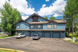 Discover this charming multi-unit property featuring a striking blue exterior and multiple garage doors, perfect for a rental portfolio or a spacious residence.