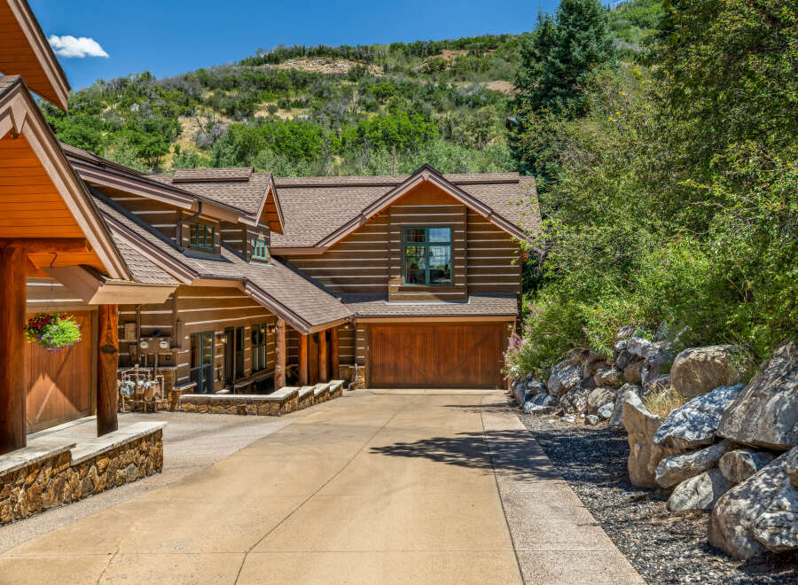 Experience rustic charm in this stunning log home nestled against a scenic hillside.