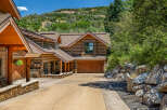 Experience rustic charm in this stunning log home nestled against a scenic hillside.