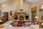 Experience rustic elegance in this stunning living room, featuring a grand stone fireplace as the centerpiece, perfect for cozy evenings.