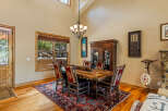 Experience rustic charm in this inviting dining room, featuring a substantial wooden table with uniquely crafted chairs upholstered in a striking Native American-inspired pattern.