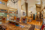 Experience rustic elegance in this spacious dining and living area, featuring a grand wooden dining table perfect for gatherings.