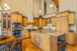 Experience culinary excellence in this spacious gourmet kitchen, featuring custom wood cabinetry, granite countertops, and a large central island perfect for meal prep and entertaining.