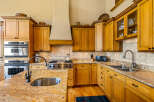 Experience culinary excellence in this stunning kitchen, featuring custom wood cabinetry and granite countertops.