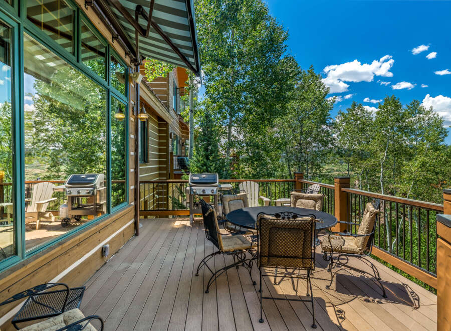 Enjoy outdoor living on this spacious deck, perfect for entertaining or relaxing amidst nature.