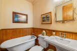 This charming bathroom features a classic clawfoot bathtub, perfect for a relaxing soak.
