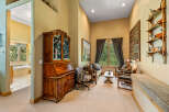 Step into this charming living area, featuring a beautiful antique secretary desk and a cozy seating arrangement perfect for relaxation.