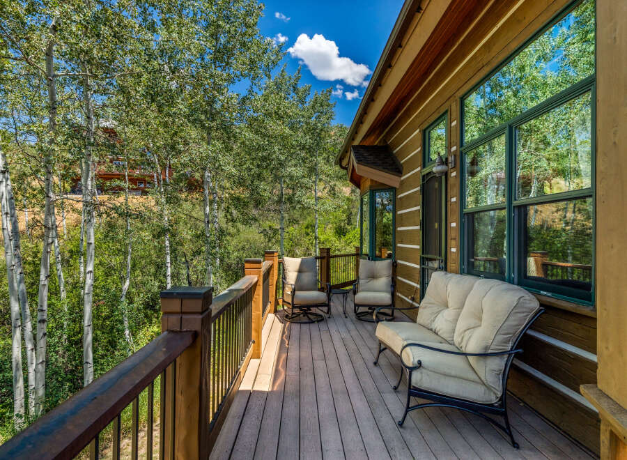Enjoy the serene mountain views from this charming log cabin's spacious deck.