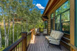 Enjoy the serene mountain views from this charming log cabin's spacious deck.