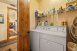 This laundry room features a spacious white washer and dryer set, perfect for handling large loads.