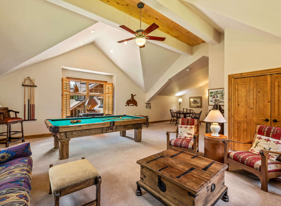 This spacious game room features a classic billiard table, perfect for friendly competitions.
