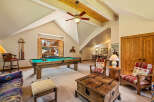This spacious game room features a classic billiard table, perfect for friendly competitions.