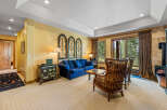 Experience cozy living in this inviting living room, featuring a plush blue sofa perfect for relaxation and a charming antique cabinet adding character.
