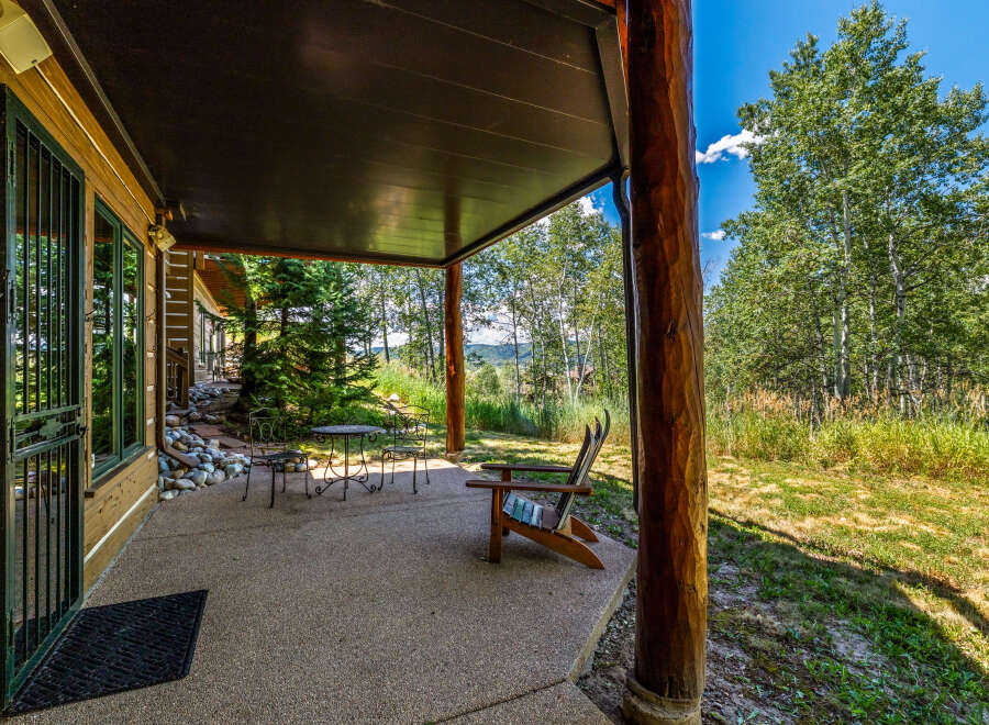 Enjoy the serene mountain views from this charming covered porch, perfect for relaxing or entertaining.