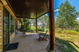 Enjoy the serene mountain views from this charming covered porch, perfect for relaxing or entertaining.