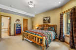 Experience rustic charm in this inviting bedroom, featuring a unique log bed and a cozy mountain-themed comforter.