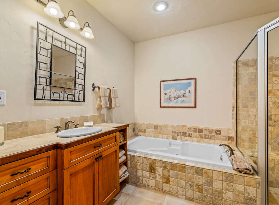 Indulge in relaxation in this luxurious bathroom featuring a spacious soaking tub, perfect for unwinding after a long day.
