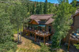 Experience luxury mountain living in this stunning log-style home, nestled amidst lush greenery and mature trees.