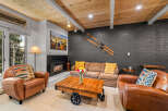 Cozy mountain living awaits in this inviting living room, featuring a warm fireplace and comfortable seating.