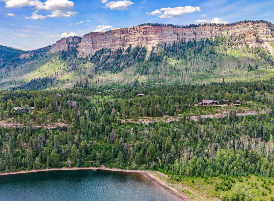 Nestled amidst a lush forest and overlooking a serene lake, this property offers a private mountain retreat.