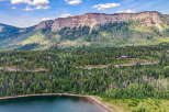 Nestled amidst a lush forest and overlooking a serene lake, this property offers a private mountain retreat.