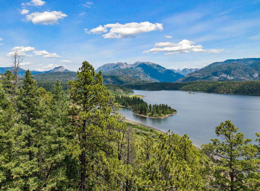 Experience breathtaking natural beauty with this stunning property offering panoramic views of a serene lake and majestic mountains.