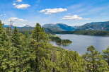 Experience breathtaking natural beauty with this stunning property offering panoramic views of a serene lake and majestic mountains.
