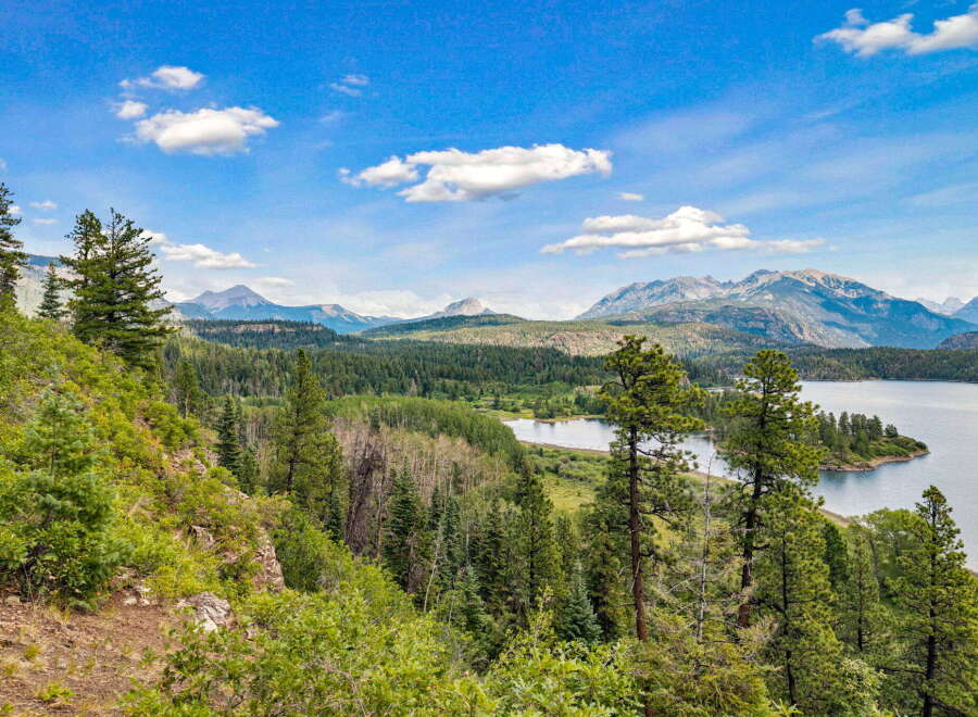 Discover breathtaking natural beauty with this stunning property offering panoramic views of a serene lake and majestic mountains.