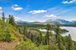 Discover breathtaking natural beauty with this stunning property offering panoramic views of a serene lake and majestic mountains.
