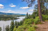 Discover breathtaking lakefront living with this stunning property offering panoramic views of a serene lake and lush, rolling hills.
