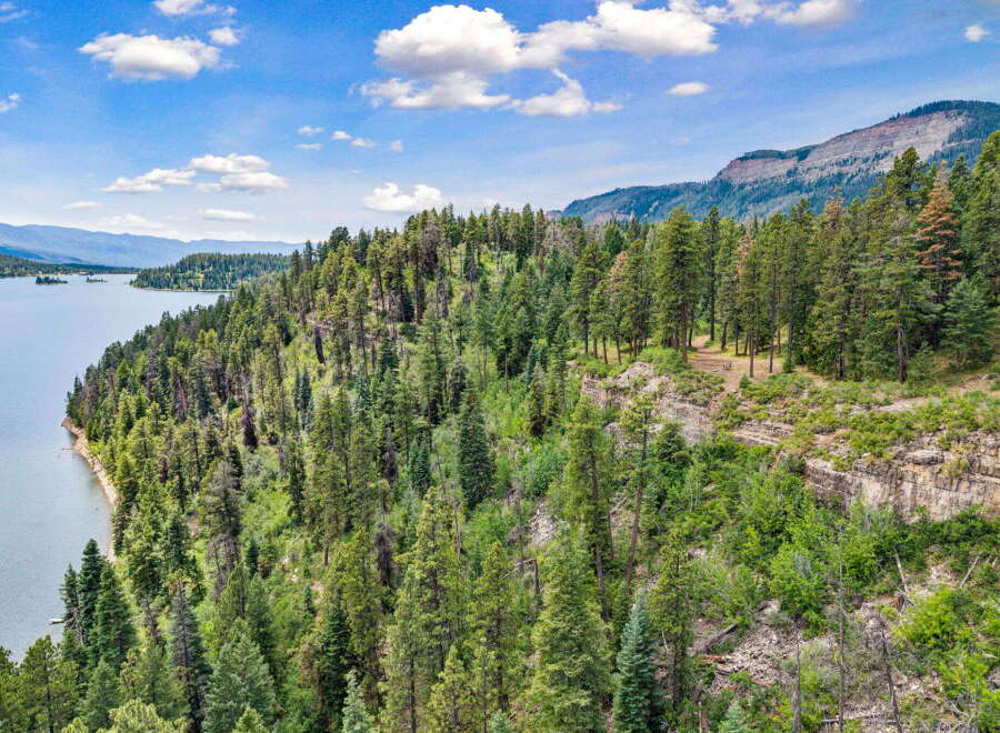 Discover breathtaking natural beauty with this stunning property overlooking a serene lake and majestic mountains.