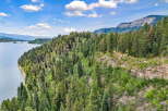 Discover breathtaking natural beauty with this stunning property overlooking a serene lake and majestic mountains.