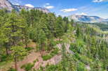 Nestled amidst a lush pine forest, this property offers a serene mountain retreat with breathtaking views.
