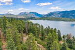 Discover breathtaking natural beauty with this stunning property offering panoramic views of a serene lake and majestic mountains.