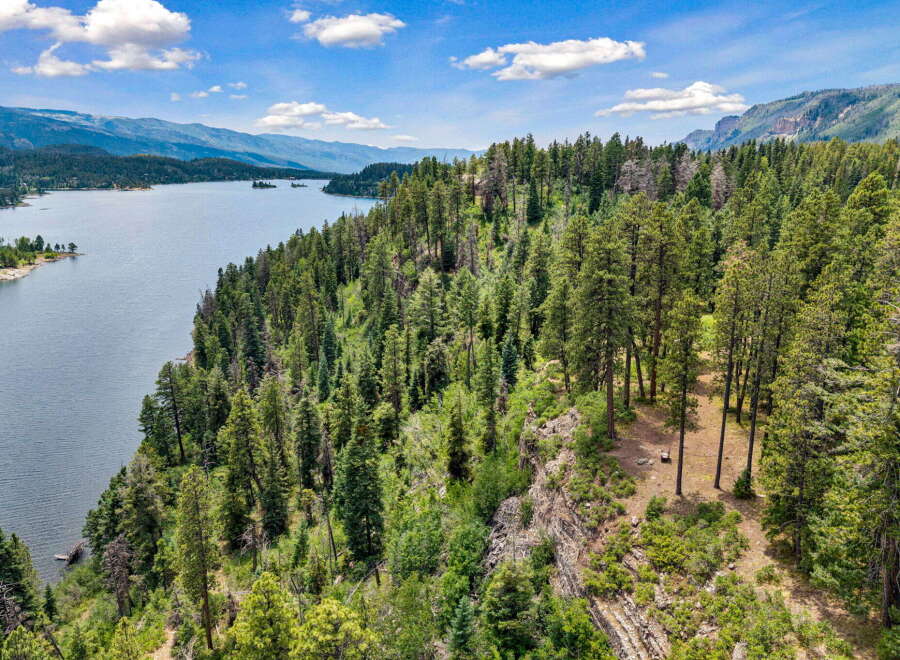 Discover breathtaking natural beauty with this stunning property overlooking a serene lake and majestic mountains.