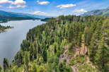 Discover breathtaking natural beauty with this stunning property overlooking a serene lake and majestic mountains.
