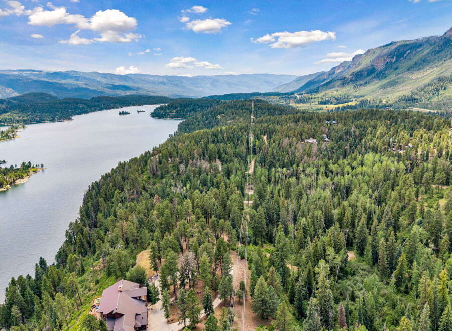 Discover this stunning property offering breathtaking panoramic views of the serene lake and majestic mountains.