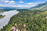 Discover this stunning property offering breathtaking panoramic views of the serene lake and majestic mountains.