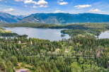 Experience breathtaking mountain and lake views from this stunning property, nestled amidst a lush forest.