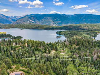 Experience breathtaking mountain and lake views from this stunning property, nestled amidst a lush forest.