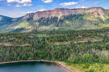 Nestled amidst a lush forest and overlooking a serene lake, this property offers a private mountain retreat.