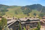 Experience luxury mountain living in this stunning property, perfectly situated against a backdrop of rolling green hills and ski slopes.