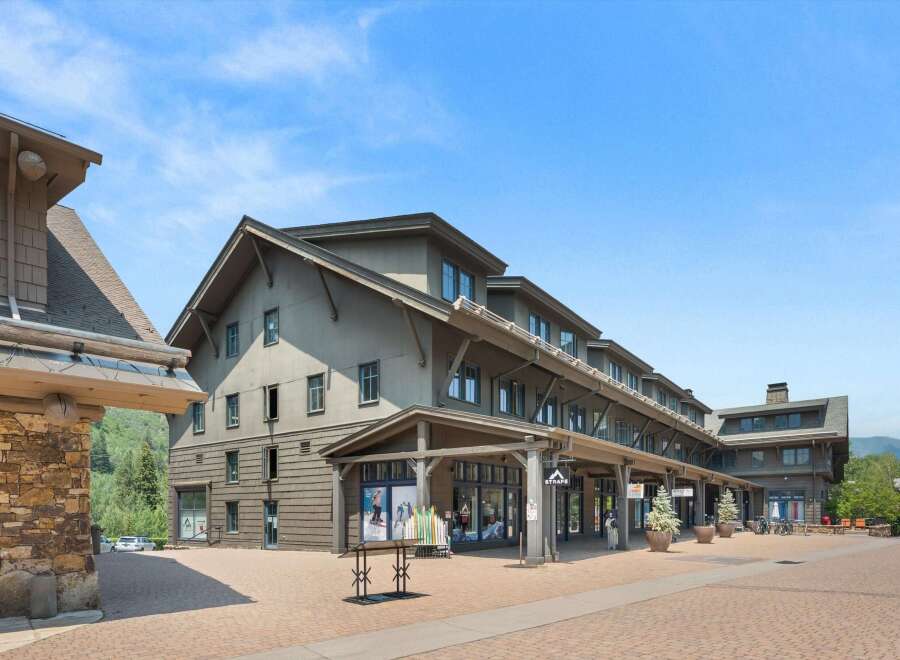 Discover this charming commercial property featuring a multi-story building with a rustic stone facade and shingle siding, perfect for retail or office spaces.