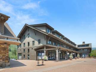 Discover this charming commercial property featuring a multi-story building with a rustic stone facade and shingle siding, perfect for retail or office spaces.